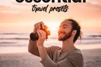 Essential Travel Presets. Shooting into the sunset on a beach, camera raised.